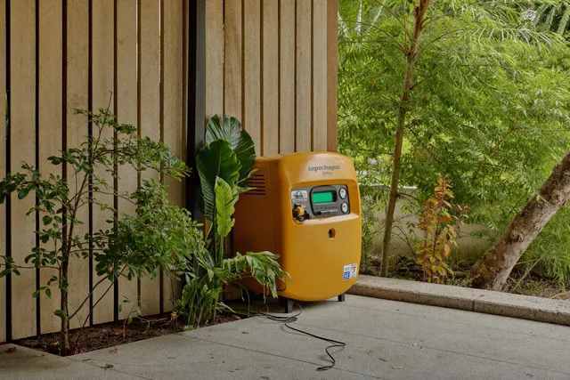 Technicians positioning a diesel generator during installation at a Bali villa