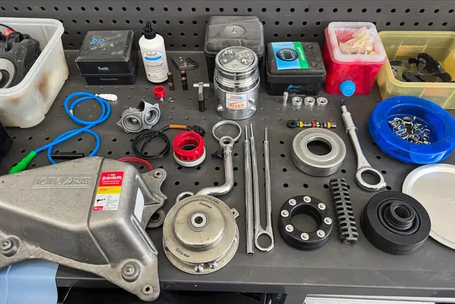 Generator spare parts and tools laid out in a Bali repair workshop